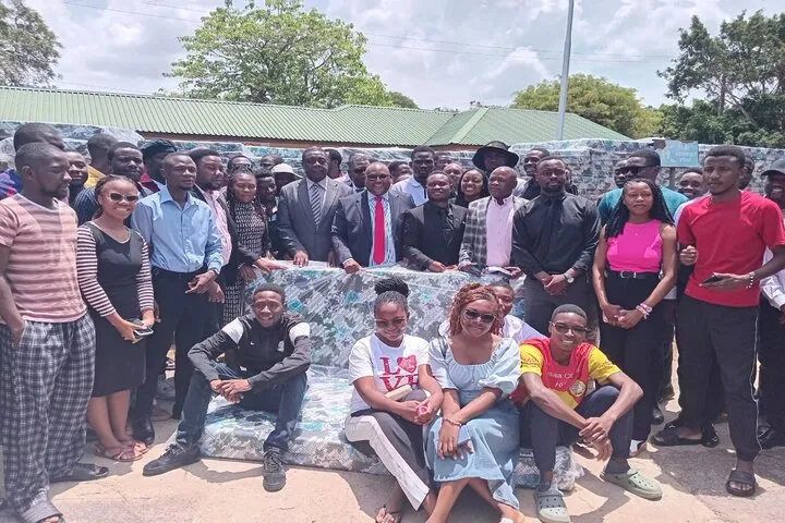 Hon Haimbe pose for a photo with students